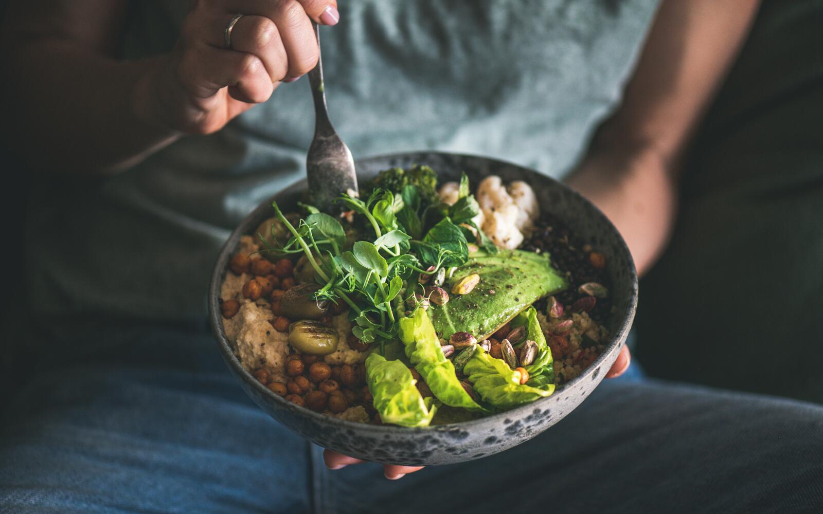 A close up shot of a Buddha bowl - a healthy food bowl with snap peas, quinoa, and other healthy foods